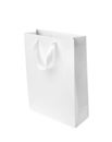 Paper shopping bag with ribbon handles on white background. Royalty Free Stock Photo