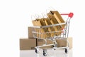Paper shopping bags in a trolley on white background. Ideas online shopping is a form of electronic commerce that allows consumers
