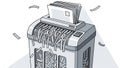 Paper Shredder Destroying Documents in Office Environment Royalty Free Stock Photo