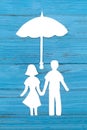 Paper silhouette of man and woman holding hands under umbrella Royalty Free Stock Photo