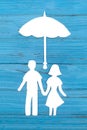 Paper silhouette of man and woman holding hands under umbrella Royalty Free Stock Photo