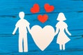 Paper silhouette of man and woman holding heart Royalty Free Stock Photo