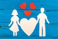 Paper silhouette of man and woman holding heart Royalty Free Stock Photo