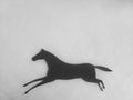 Paper silhouette of running horse on white background