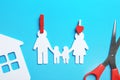 Paper silhouettes of family with pins, house and scissors on color background, flat lay. Life insurance