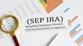 Paper with Simplified Employee Pension Individual Retirement Arrangement SEP IRA on a chart
