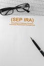Paper with Simplified Employee Pension Individual Retirement Arrangement SEP IRA on a table