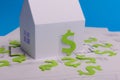 Paper skyscrapers , us dollar money, house projects plan and blueprints on blue background paper. Minimalistic and simple concept Royalty Free Stock Photo