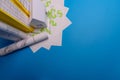 Paper skyscrapers , us dollar money, house projects plan and blueprints on blue background paper. Minimalistic and simple concept Royalty Free Stock Photo