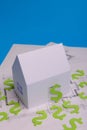 Paper skyscrapers , us dollar money, house projects plan and blueprints on blue background paper. Minimalistic and simple concept Royalty Free Stock Photo