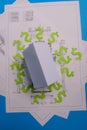 Paper skyscrapers , us dollar money, house projects plan and blueprints on blue background paper. Minimalistic and simple concept Royalty Free Stock Photo