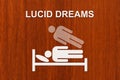 Paper sleeping man on bed with text LUCID DREAMS