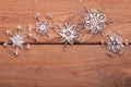 Paper snowflakes made with quilling technique on a wooden surface