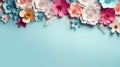 Paper spring flowers on turquoise background with copy space