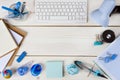 Paper, stationery and keyboard on wooden planks background