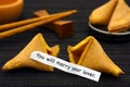 Paper strip with phrase You Will Marry Your Lover with fortune c