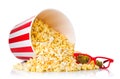 Paper striped bucket and 3D glasses on a heap of popcorn isolated on white Royalty Free Stock Photo