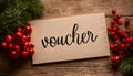 Paper tag with word voucher on christmas tree branch background Royalty Free Stock Photo
