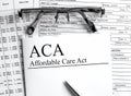 Paper with text ACA Affardable Care Act on a table Royalty Free Stock Photo
