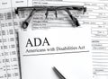 Paper with text ADA Americans with Disabilities Act on a table Royalty Free Stock Photo