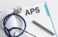 Paper with text APS on a table with stethoscope