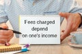 Paper with text - Fees charged depend on one`s income