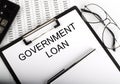 Paper with text GOVERNMENT LOAN on table Royalty Free Stock Photo