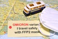 Paper with text `OMICRON Variant I travel safely with FFP2 masks` above map of Europe with ffp2 type protection masks and a mode Royalty Free Stock Photo