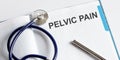 Paper with text PELVIC PAIN on table with stethoscope