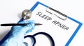 Paper with text SLEEP APNEA on a table with stethoscope