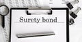 Paper with text SURETY BOND on a table