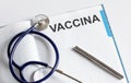 Paper with text VACCINA on table with stethoscope Royalty Free Stock Photo