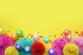 Paper texture flowers with confetti and baloons on yellow background. Birthday, holiday or party background. Flat lay style. Royalty Free Stock Photo