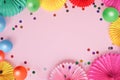 Paper texture flowers with different baloons on pink background. Birthday, holiday or party background. Flat lay style.