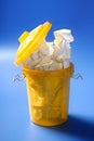 Paper trash in yellow over blue background Royalty Free Stock Photo