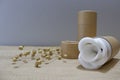 Paper tube with white cotton disks inside on wooden background. Recycle concept showing how to reuse plastic free Royalty Free Stock Photo