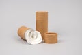 Paper tubes with white cotton disks inside on grey background with copyspace. Reusable packaging and recycling concept showing how Royalty Free Stock Photo