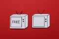 Paper TVs with word Fake and empty screen on red background, flat lay. Information warfare concept Royalty Free Stock Photo