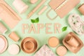 Paper utensils, disposable tableware set with text PAPER made with paper letters over light green background Royalty Free Stock Photo