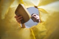 Paper waste sorting and recycling - woman throwing piece of cardboard in yellow bag