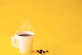 Paper white cup is aroma coffee,beans and smoke on yellow background. copy space for your text Royalty Free Stock Photo