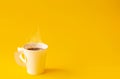 Paper white cup is aroma coffee and smoke on yellow background. copy space for your text Royalty Free Stock Photo