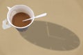 Paper white cup of coffee and time shadow