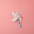 Paper windmill on pink background. minimal style. Royalty Free Stock Photo
