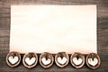 Paper on wooden background with abstract hearts