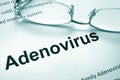 Paper with word adenovirus and glasses. Royalty Free Stock Photo