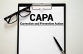 Paper with words CAPA Corrective and Preventive action plans