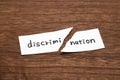 The paper written as discrimination is torn on wood. Concept of abolition of discrimination.