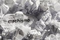 Paper written machismo, portuguese and spanish word for chauvism. Concept of old and abandoned idea or practice. Royalty Free Stock Photo