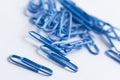 Paperclips scattered on white surface